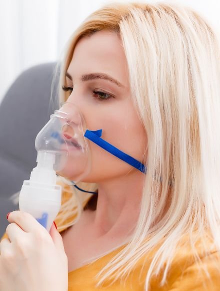 female nebulizing herself